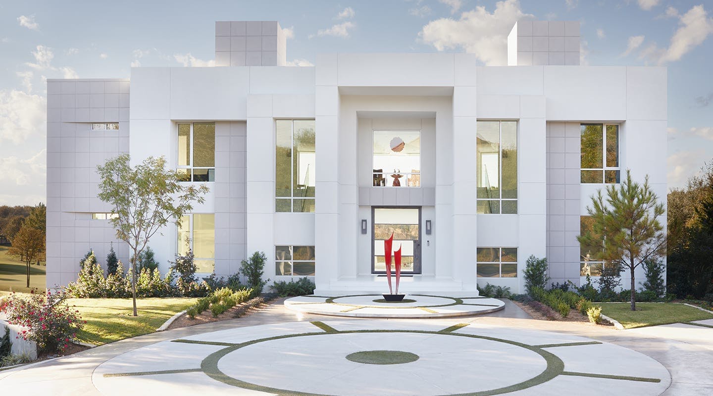 white modern home with circle driveway